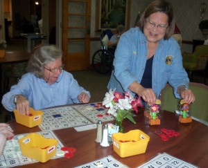 Lion Marcia Selva presents gifts to bingo players at Fairfax Nursing Centger