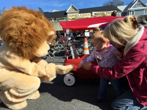 Lion mascot meets children